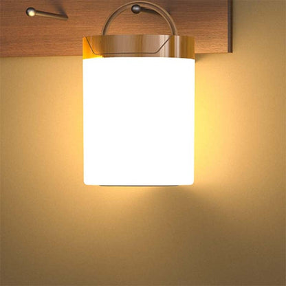 Portable Touch Control LED Bedside Night Light hangs on a wooden surface.