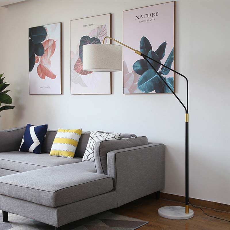Living room with a gray corner sofa, throw pillows, and the Reader Floor Lamp.