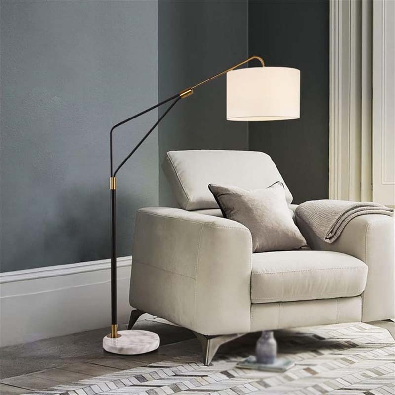 Beige armchair with a floor lamp in a room with dark gray walls.