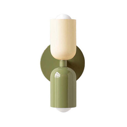 Wall sconce with green base and beige shade on a white background