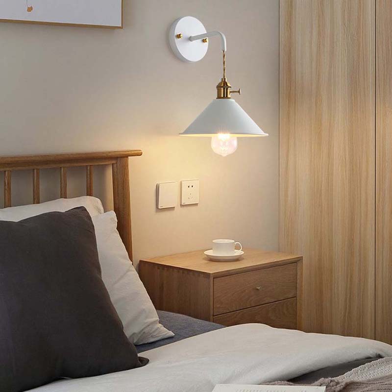 Bedroom with wooden headboard, nightstand, and wall-mounted lamp.