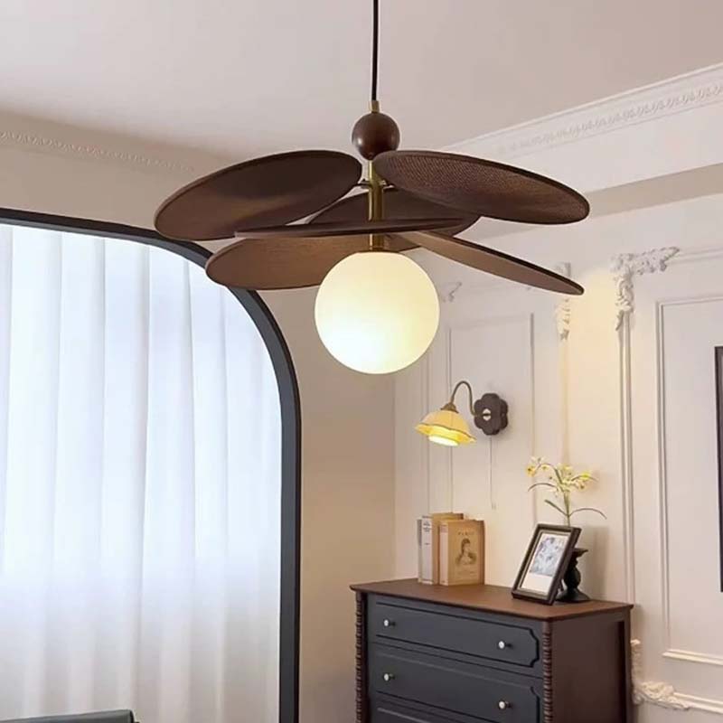 Rustic raffia pendant light over dining table.