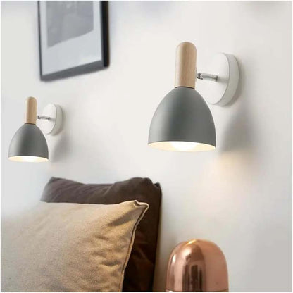 Two wall-mounted lamps with gray shades and wooden accents on a white wall.