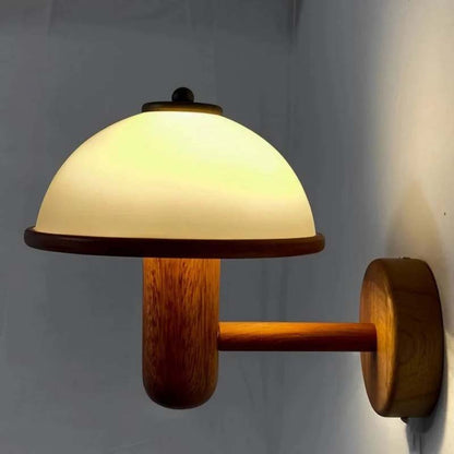 Wooden wall lamp with a white glass shade on a plain background