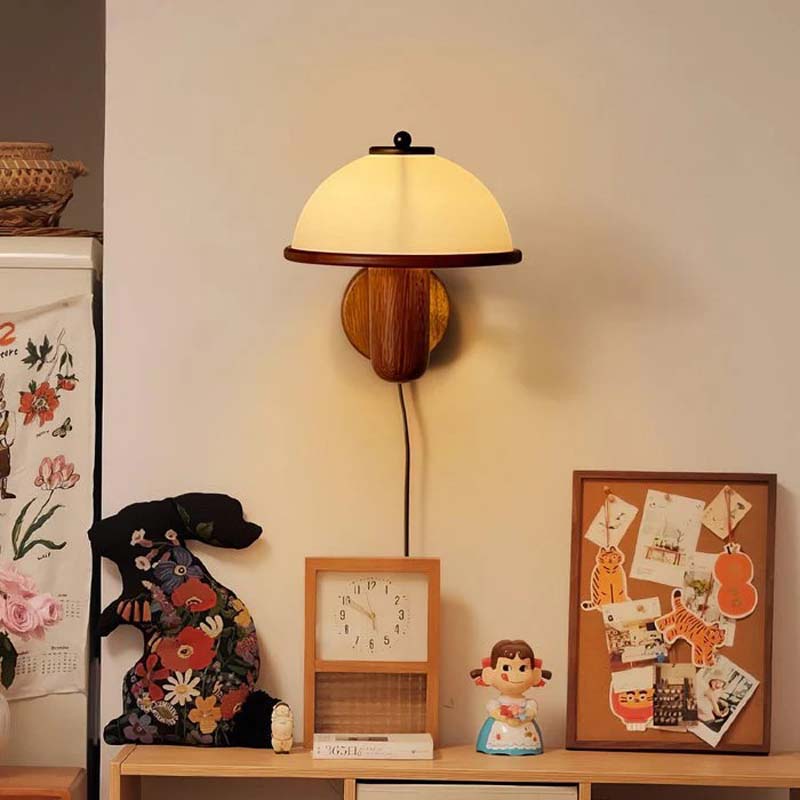 Wall-mounted lamp with decorative items on a shelf in a room.