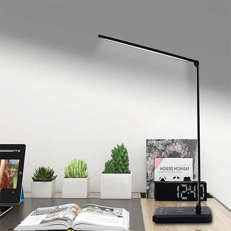 Modern desk lamp on a desk with plants and a tablet in a minimalistic office setting