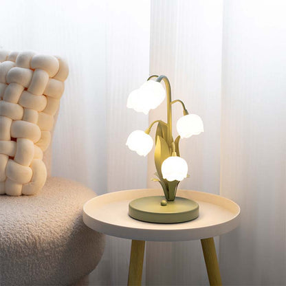 Modern table lamp with multiple lights on a small round table next to a textured chair.