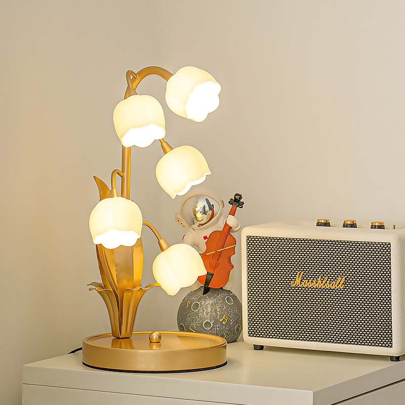 Decorative table lamp with multiple light bulbs next to a Marshall amplifier on a surface.