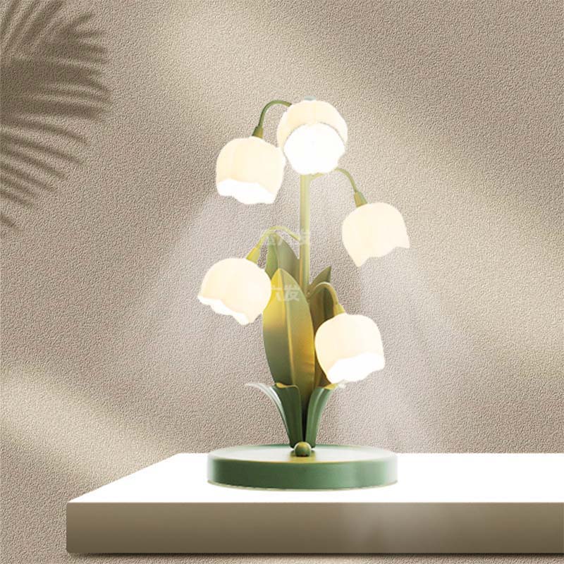 Decorative table lamp with white bulbs and green base on a neutral background