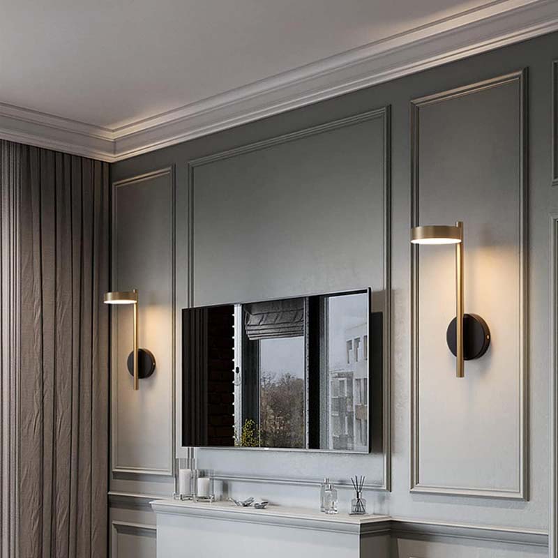 Modern room with gray walls, a TV, and wall sconces.