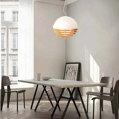 Sunset pendant lamp over a rectangular table in a Scandinavian-style interior with large windows.