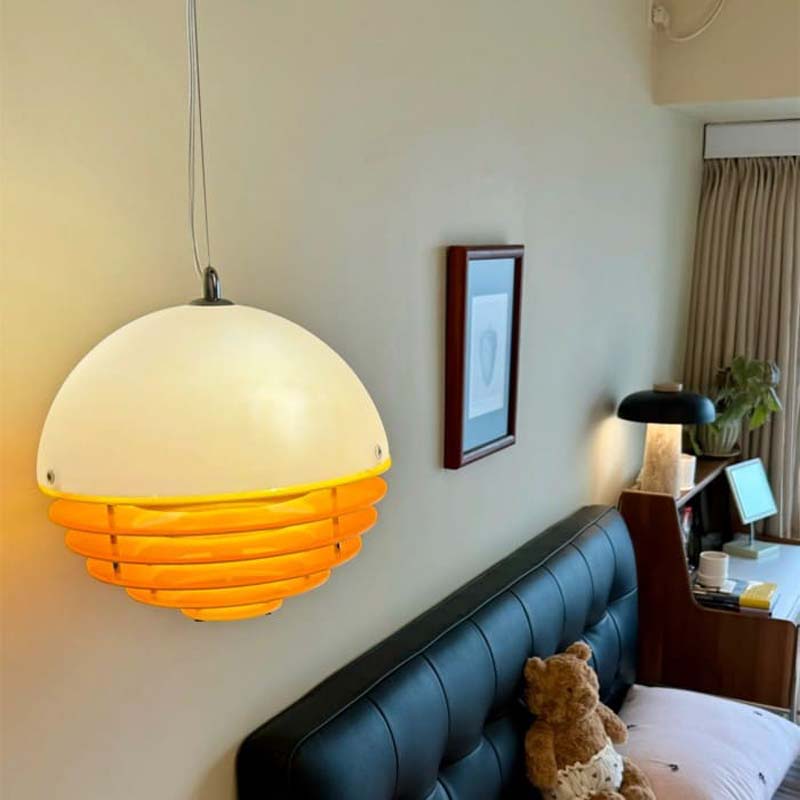 Sunset pendant light above a bed in a cozy bedroom