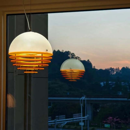 Sunset pendant light turned on with reflection in a window