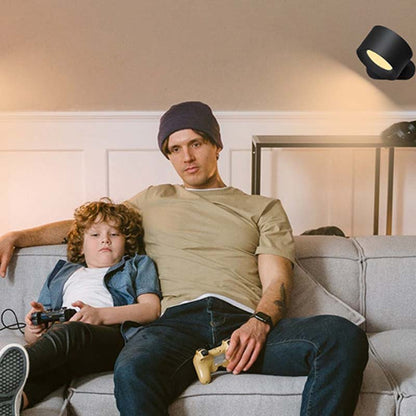 Touch LED Wall Sconce over the sofa on which a man and a child are sitting with game controllers