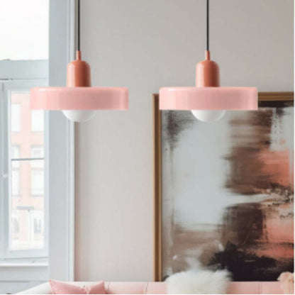 Two Color Glow Pendant Lights in a room with a painting and a window in the background.