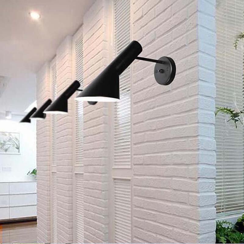 Modern black wall sconces on a textured white wall