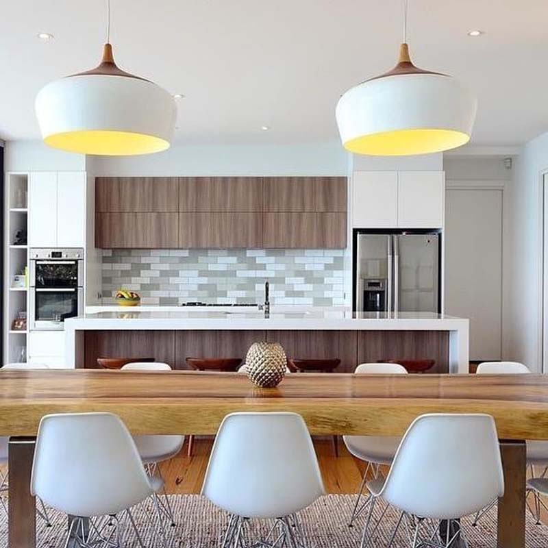 Pendant Lamp Dome in a modern kitchen with a wooden dining table and white chairs.