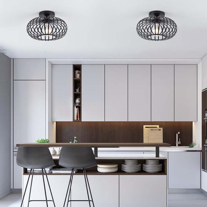 Two ceiling lights above a table in a bright kitchen with two chairs