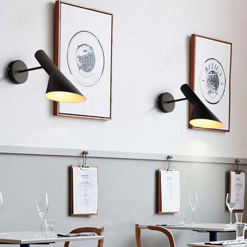 Modern wall lights with framed artwork in a restaurant setting