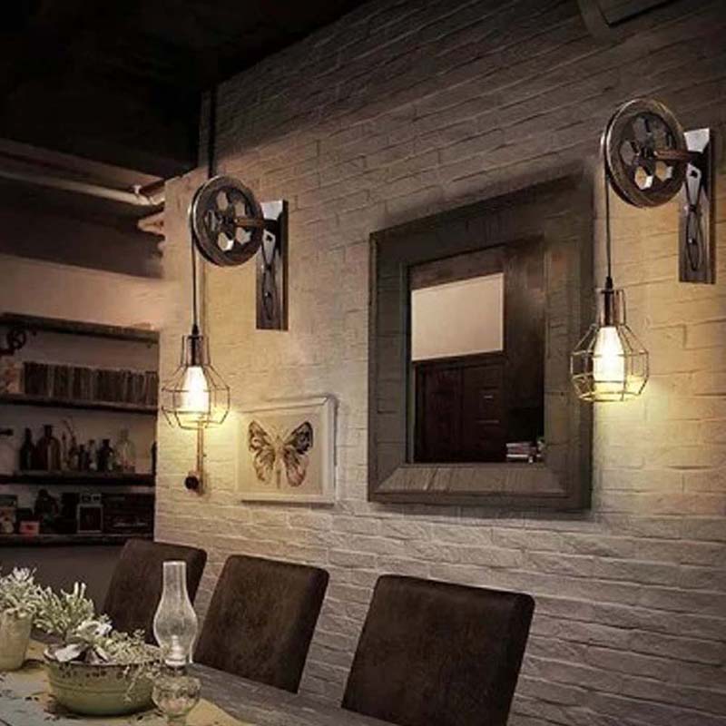 Dining area with rustic wall lights, mirror, and decorative elements.