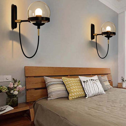 Bedroom with wooden headboard, pillows, and wall sconces.