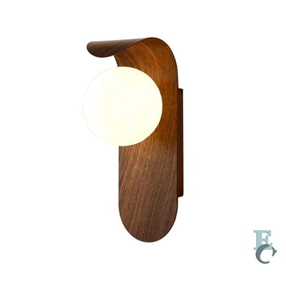Metal wall lamp with a round bulb on a white background.