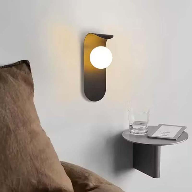 Modern wall-mounted lamp with a side table next to a brown cushion on a light gray background