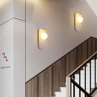 Modern wall lights on a staircase with a visible brand logo.