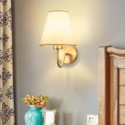 Wall-mounted lamp with a soft glow in a room setting.