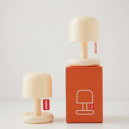 Mini and large mushroom bedside lamps displayed with the product packaging, showcasing the two available sizes and modern minimalist design for cozy home lighting