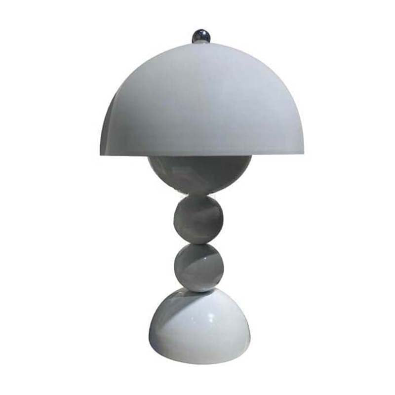 Modern table lamp with a white shade and stacked circular base on a white background