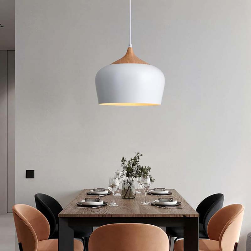 Dining area with a modern pendant light, wooden table, and chairs.