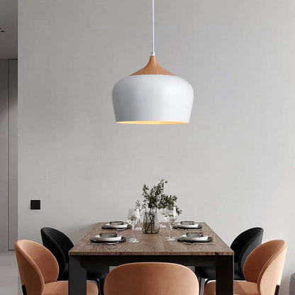 Dining area with a modern pendant light, wooden table, and chairs.