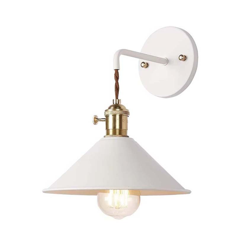 Wall-mounted light fixture with white shade and brass accents on a white background