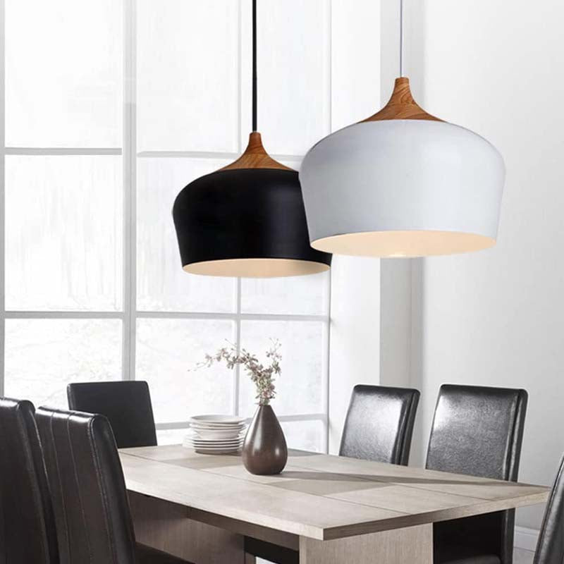Dining room with two pendant lights hanging above a table.