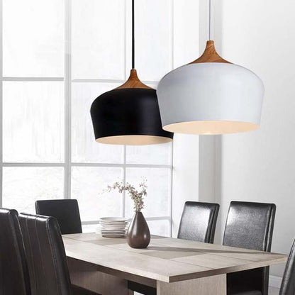 Dining room with two pendant lights hanging above a table.