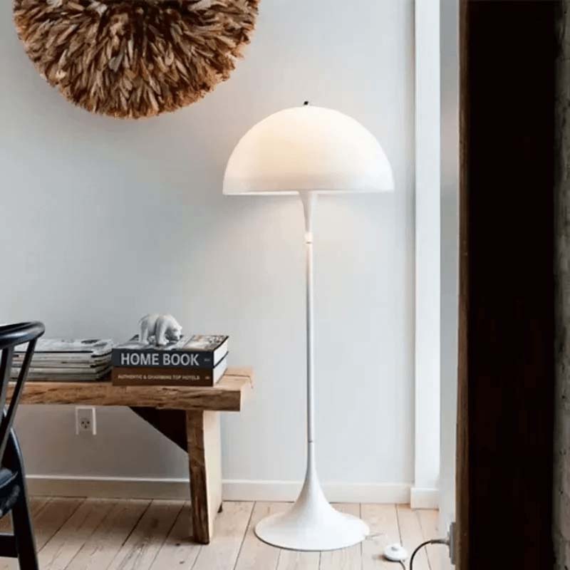 White floor lamp in a modern interior with a wooden table and decorative items.