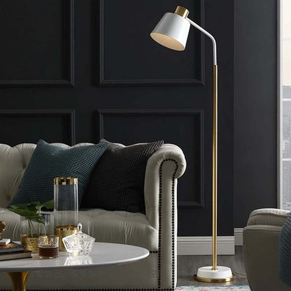 White floor lamp in a modern living room, next to a gray sofa, armchair and coffee table, against a background of dark paneling