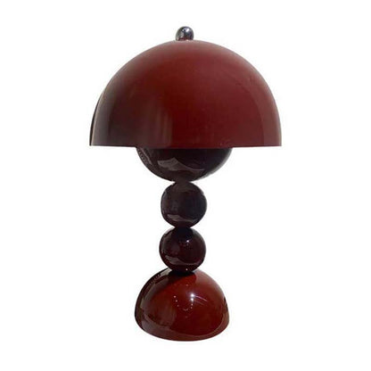 Table lamp with a red-brown shade and cylindrical base on a white background