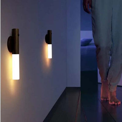 Wireless LED wall light with motion sensor providing automatic night lighting in a hallway for safe indoor navigation