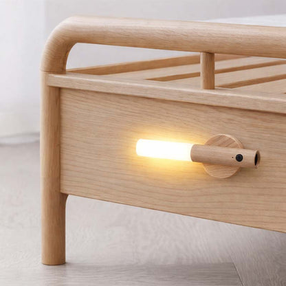 Wireless LED bedside wall light with motion sensor creating soft night lighting in a bedroom for nighttime comfort