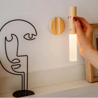 Magnetic wireless LED wall light with motion sensor installed in hallway, providing rechargeable night lighting for stairs and bedroom use