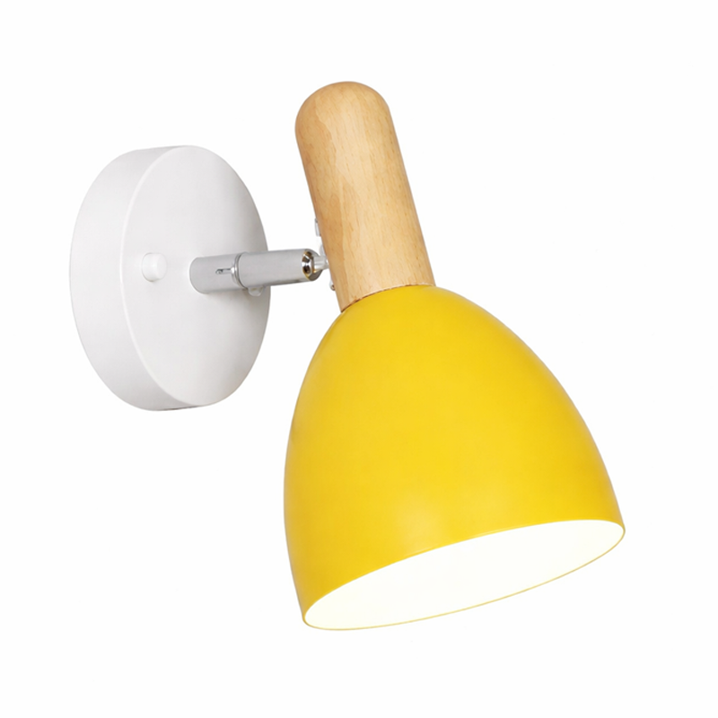 Wall-mounted lamp with yellow shade and wooden arm on a white 