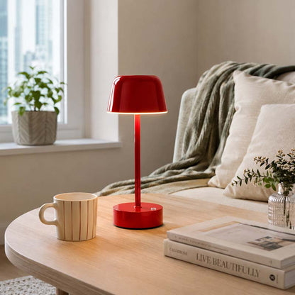 Red Rechargeable Cordless Touch LED Table Lamp on a table next to a sofa
