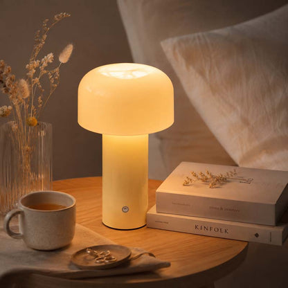 Rechargeable Mushroom LED Table Lamp sits on a wooden nightstand next to a mug, books, and dried flowers.