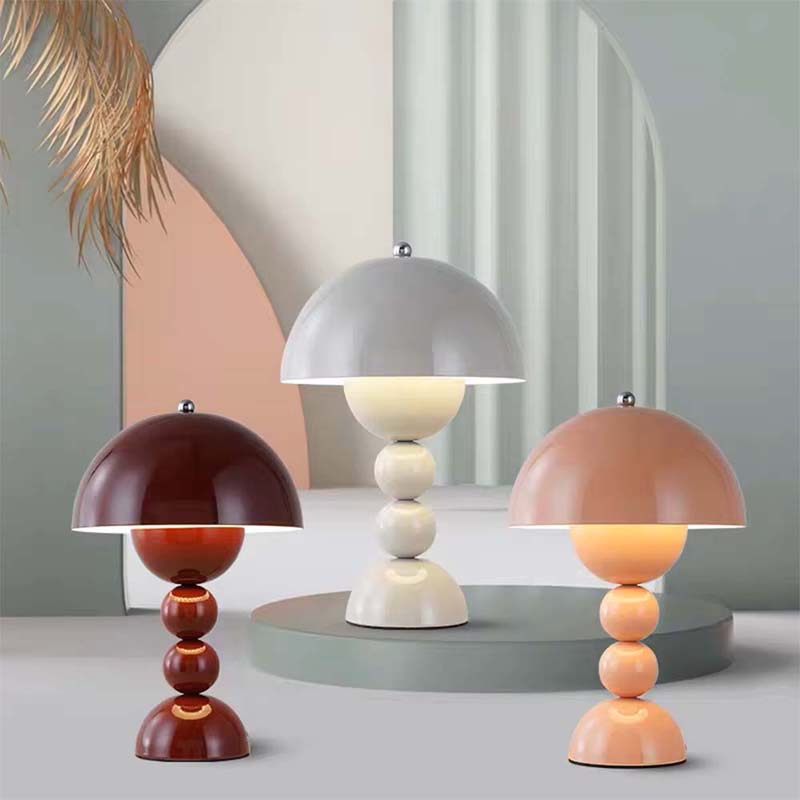 Three colorful table lamps with unique designs on a neutral background