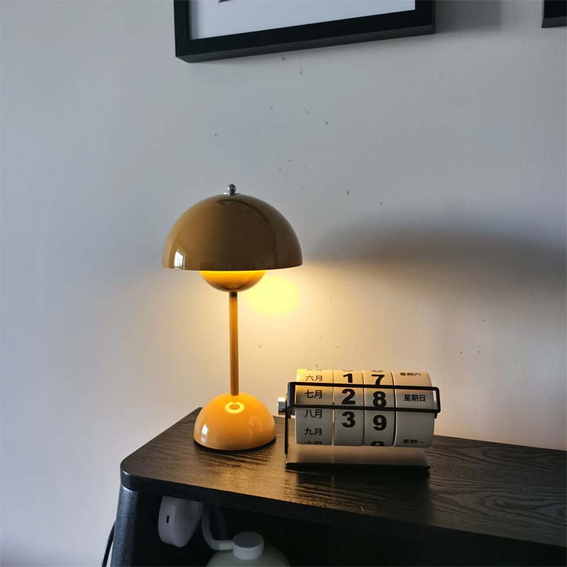 Yellow lamp on a wooden surface with a calendar in the background