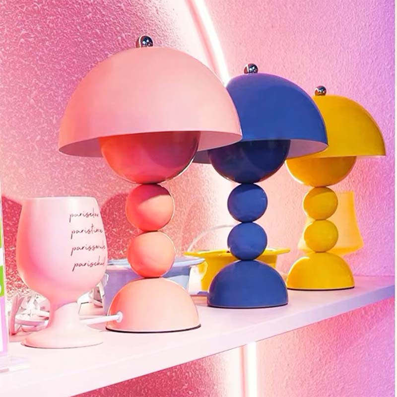 Colorful table lamps with geometric designs on a pink background