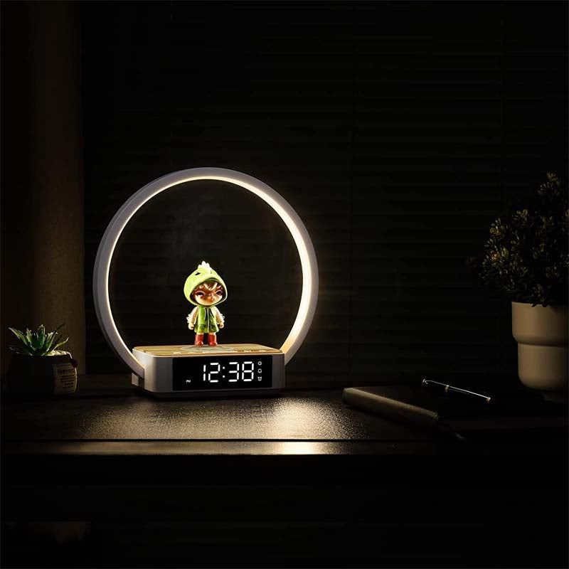 Table lamp with digital clock displaying time, surrounded by decorative items on a dark background