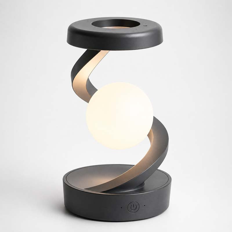 Saturn Helix – LED Desk Lamp with Wireless Charging features a spiral design with a white illuminated spherical shade, matte black top ring and matching round base on a light grey background.